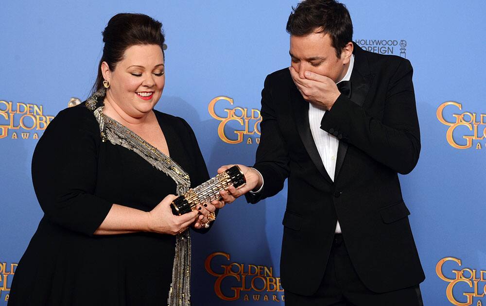 Melissa McCarthy, left, and Jimmy Fallon pose in the press room at the 71st annual Golden Globe Awards.