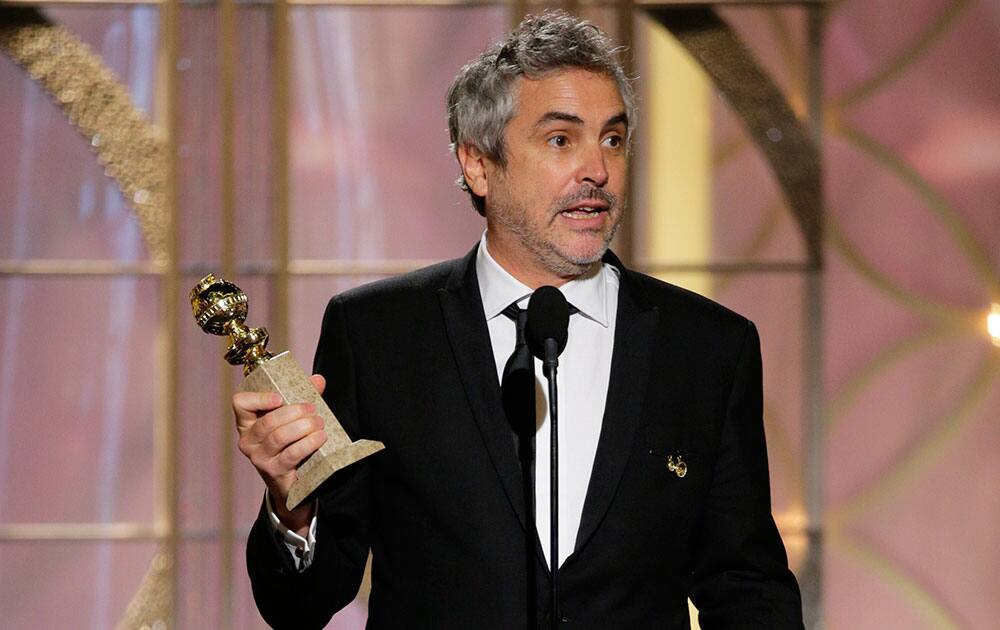 Alfonso Cuaron accepting the award for best director for `Gravity` during the 71st annual Golden Globe Awards.