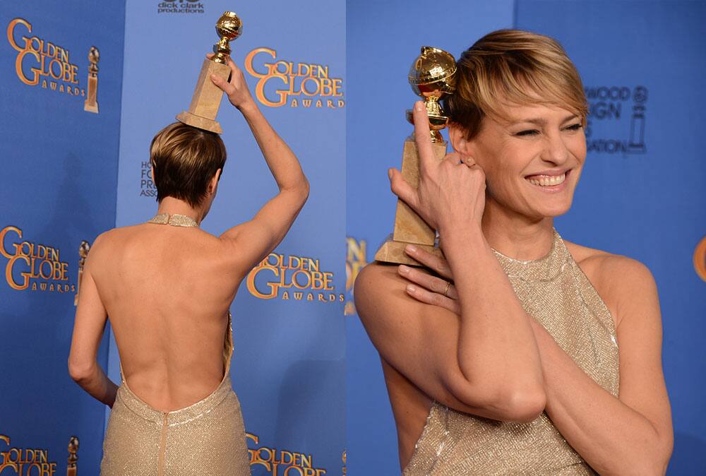 Robin Wright poses in the press room with the award for best actress in a television series - drama for `House of Cards` at the 71st annual Golden Globe Awards.