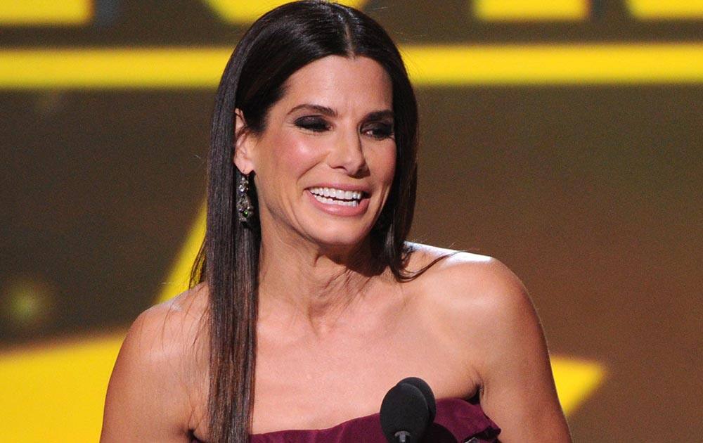 Sandra Bullock accepts the award for best actress in an action movie for 'Gravity' at the 19th annual Critics' Choice Movie Awards at the Barker Hangar, in Santa Monica, Calif.