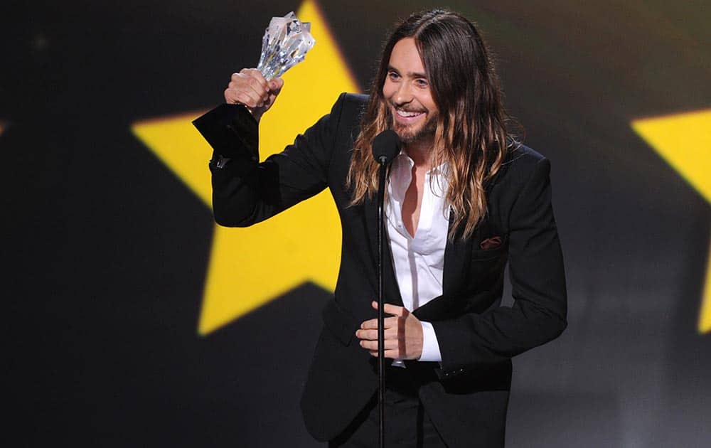 Jared Leto accepts the award for best supporting actor for 'Dallas Buyers Club' at the 19th annual Critics' Choice Movie Awards at the Barker Hangar, in Santa Monica, Calif.