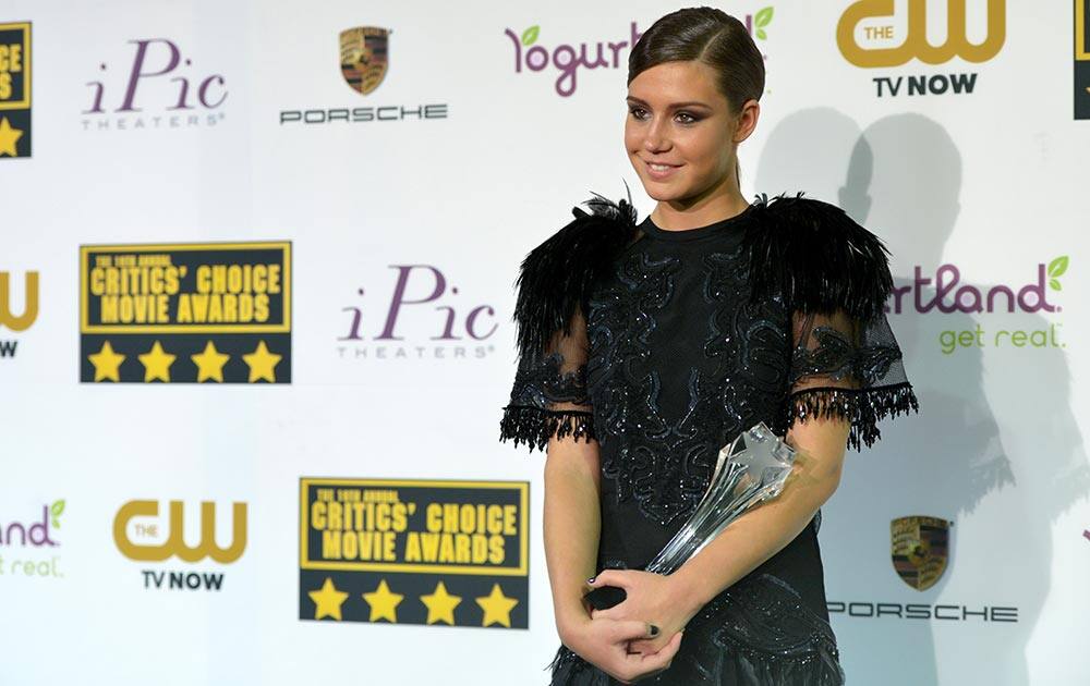 Adele Exarchopoulos poses with the award for best young actor/actress for 'Blue Is the Warmest Color' in the press room at the 19th annual Critics' Choice Movie Awards at the Barker Hangar, in Santa Monica, Calif.