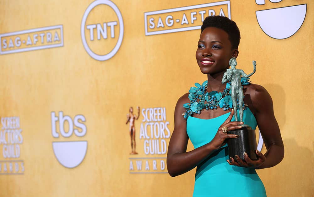 Lupita Nyong'o poses with the award for outstanding performance by a female actor in a supporting role for â??12 Years a Slaveâ?? in the press room at the 20th annual Screen Actors Guild Awards at the Shrine Auditorium.