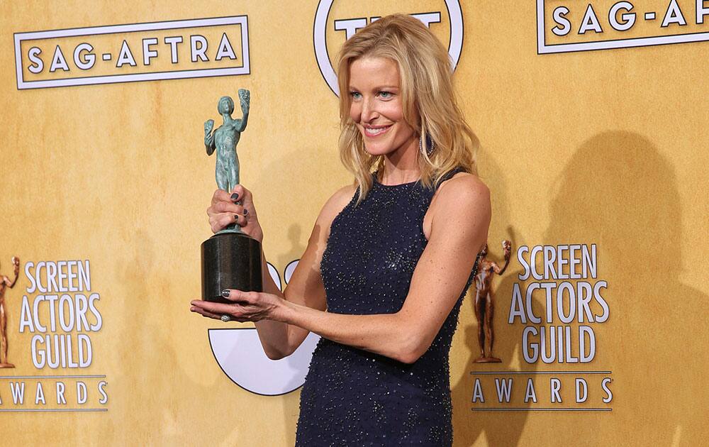 Anna Gunn poses in the press room with the award for outstanding performance by an ensemble in a drama series for `Breaking Bad` at the 20th annual Screen Actors Guild Awards at the Shrine Auditorium.
