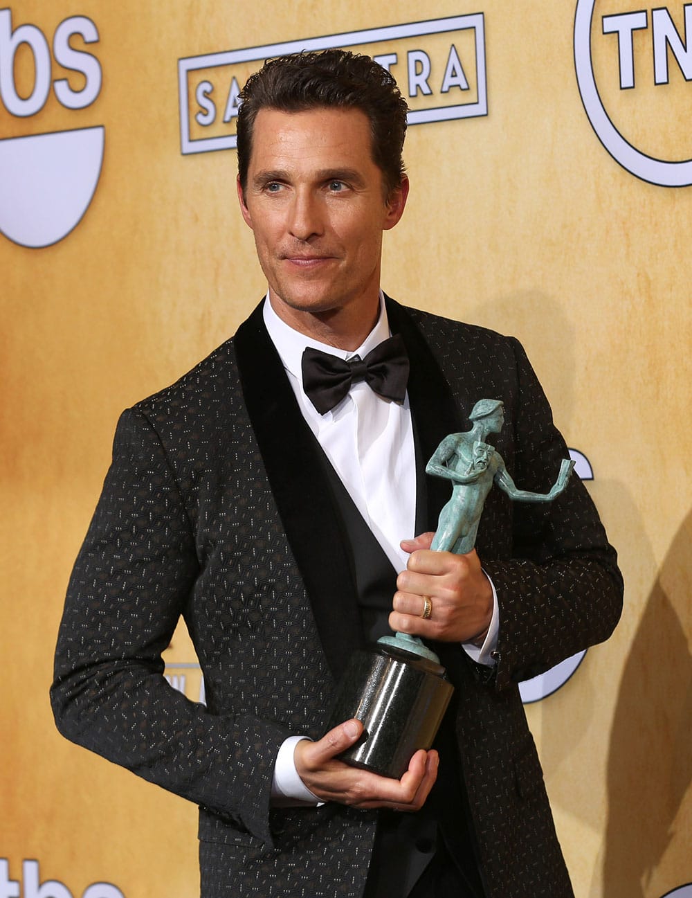 Matthew McConaughey poses in the press room with the award for outstanding performance by a male actor in a leading role for `Dallas Buyers` at the 20th annual Screen Actors Guild Awards at the Shrine Auditorium.