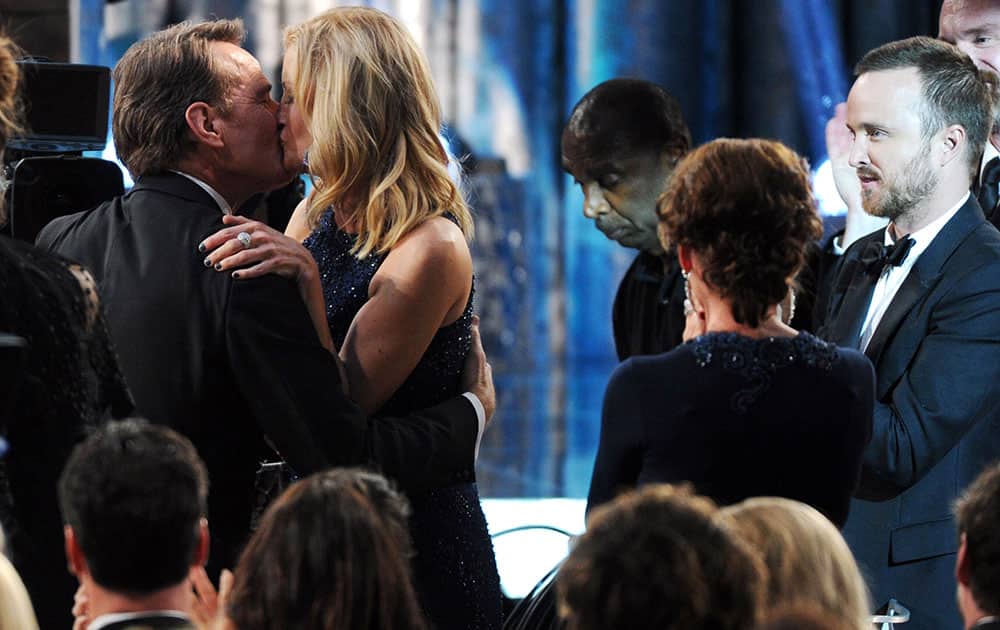 Bryan Cranston, embraces Anna Gunn after winning the award for outstanding performance by a male actor in a drama series for `Breaking Bad` at the 20th annual Screen Actors Guild Awards at the Shrine Auditorium.