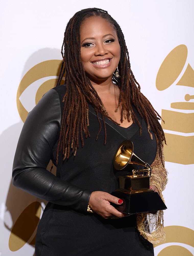 Lalah Hathaway poses in the press room with the award for best R&B performance for `Something` at the 56th annual GRAMMY Awards.