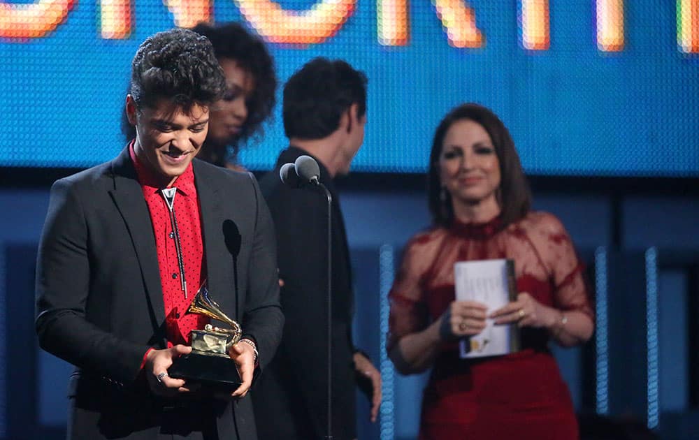 Bruno Mars accepts the award for best pop vocal album for `Unorthodox Jukebox` at the 56th annual Grammy Awards.