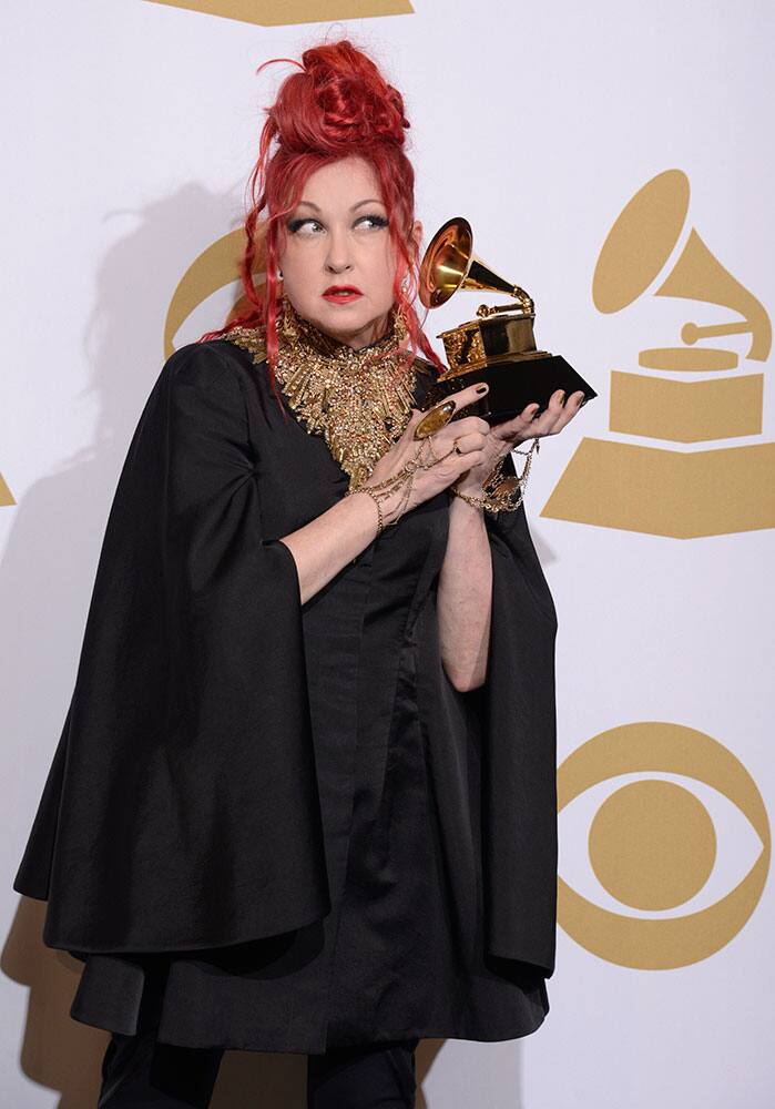 Cyndi Lauper poses in the press room with the award for best musical theater album for `Kinky Boots` at the 56th annual Grammy Awards.