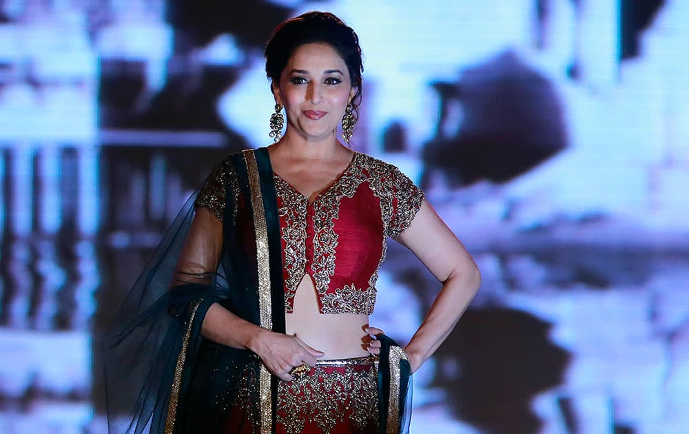 Bollywood actress Madhuri Dixit displays an outfit by Indian designer Manish Malhotra during a fashion show to support the cause of saving and empowering the female child in Mumbai.