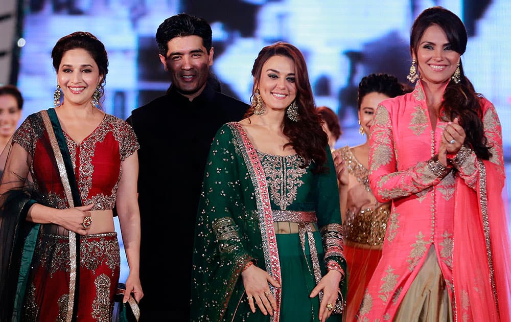 Bollywood actresses Madhuri Dixit, left, Lara Dutta right, and Prety Zinta wear designs by Indian designer Manish Malhotra, second left, during a fashion show to support the cause of saving and empowering the female child in Mumbai.