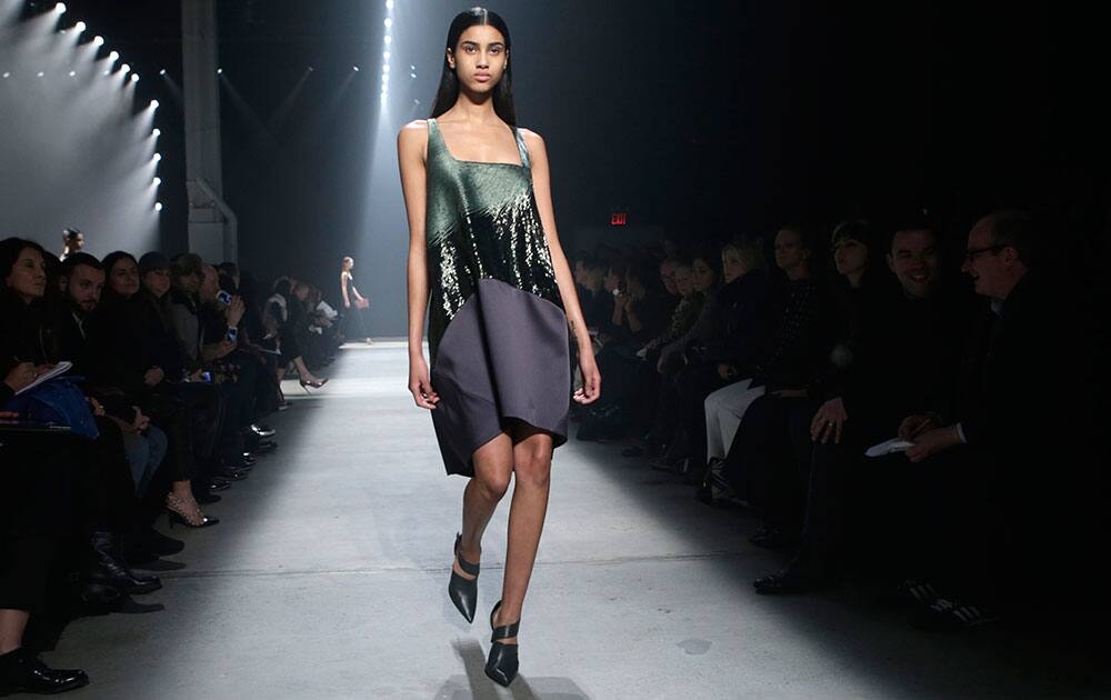 A model walks the runway during the showing of the Narciso Rodriguez Fall 2014 collection at Fashion Week in New York.