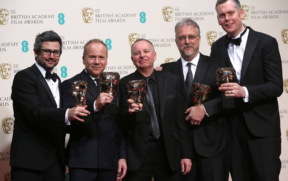 From left, Christopher Benstead, Skip Lievsay, Chris Munro, Glenn Freemantle and Niv Adiri, winners of best sound pose for photographers in the winners room at the EE British Academy Film Awards held at the Royal Opera House.