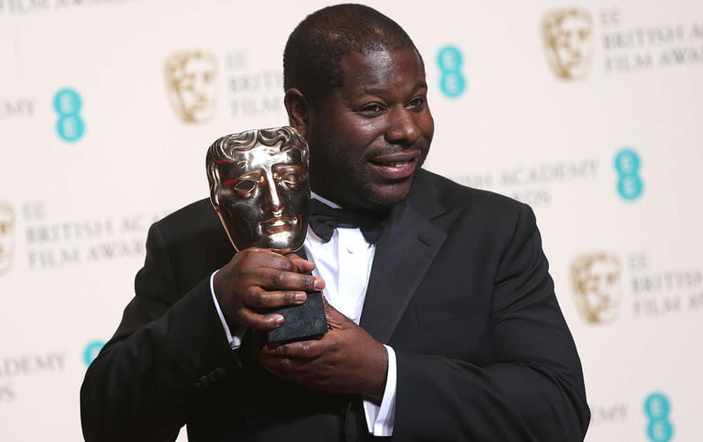 Steve McQueen winner of best film poses for photographers in the winners room at the EE British Academy Film Awards held at the Royal Opera House.