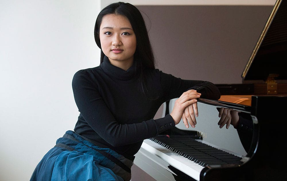 Pianist Karin Kei Nagano, 15, poses in Montreal, Tuesday, Feb. 18 2014, to promote her first album,`Mozart's `Happy Medium': Two concertos (K. 414 and K.415).`