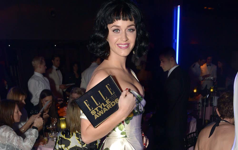 US singer Katy Perry poses with the ELLE Woman of the Year award as she attends the ELLE Style Awards 2014 after party at One Embankment in London. 