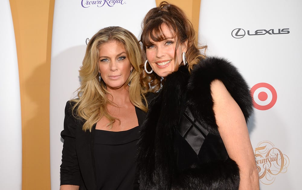 Models Rachel Hunter, left, and Carol Alt attend the 2014 Sports Illustrated Swimsuit 50th Anniversary Issue kickoff event at Swimsuit Beach House in New York.