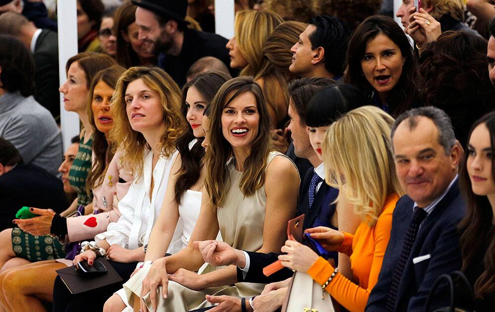 Actress Hilary Swank, center, attends the Salvatore Ferragamo women's Fall-Winter 2014-15 collection, part of the Milan Fashion Week.