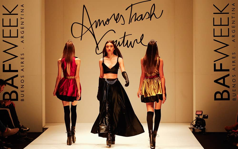 Models wear creations from the Amores Trash Couture collection during Buenos Aires fashion.