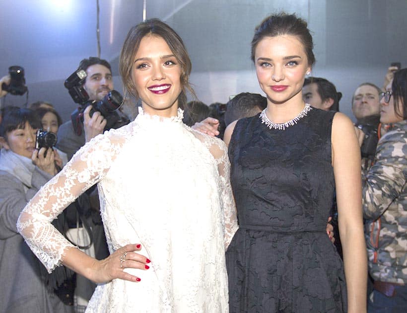 Jessica Alba, left and Miranda Kerr pose prior to the show of H&M's ready-to-wear fall/winter 2014-2015 fashion collection presented in Paris.