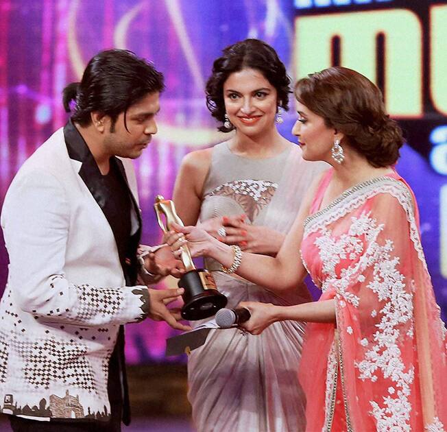 Madhuri Dixit presents award to a winner during the 6th Mirchi Music Awards 2014 in Mumbai.