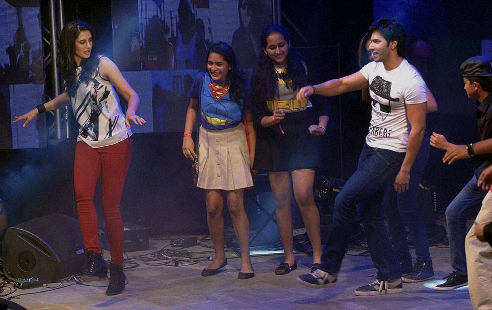 Bollywood actress Nargis Fakri with actor Varun Dhavan perform during an event in Mumbai.