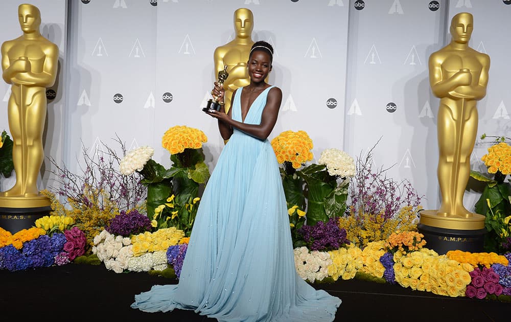 Lupita Nyong'o poses in the press room with the award for best actress in a supporting role for '12 Years a Slave' during the Oscars at the Dolby Theatre, in Los Angeles.