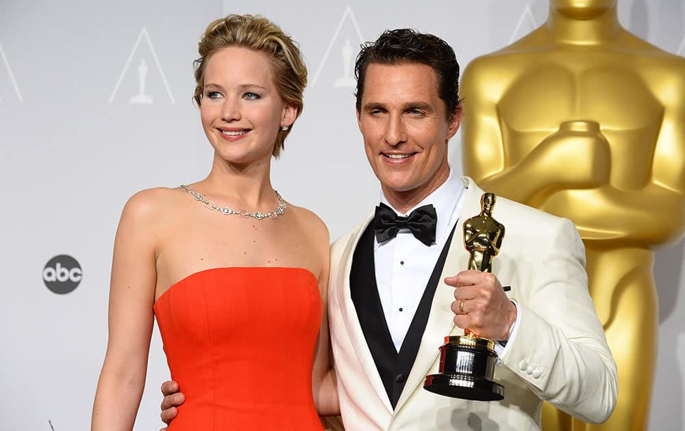 Matthew McConaughey, winner of the award for best actor for his role in the 'Dallas Buyers Club' poses with Jennifer Lawrence in the press room during the Oscars at the Dolby Theatre, in Los Angeles.