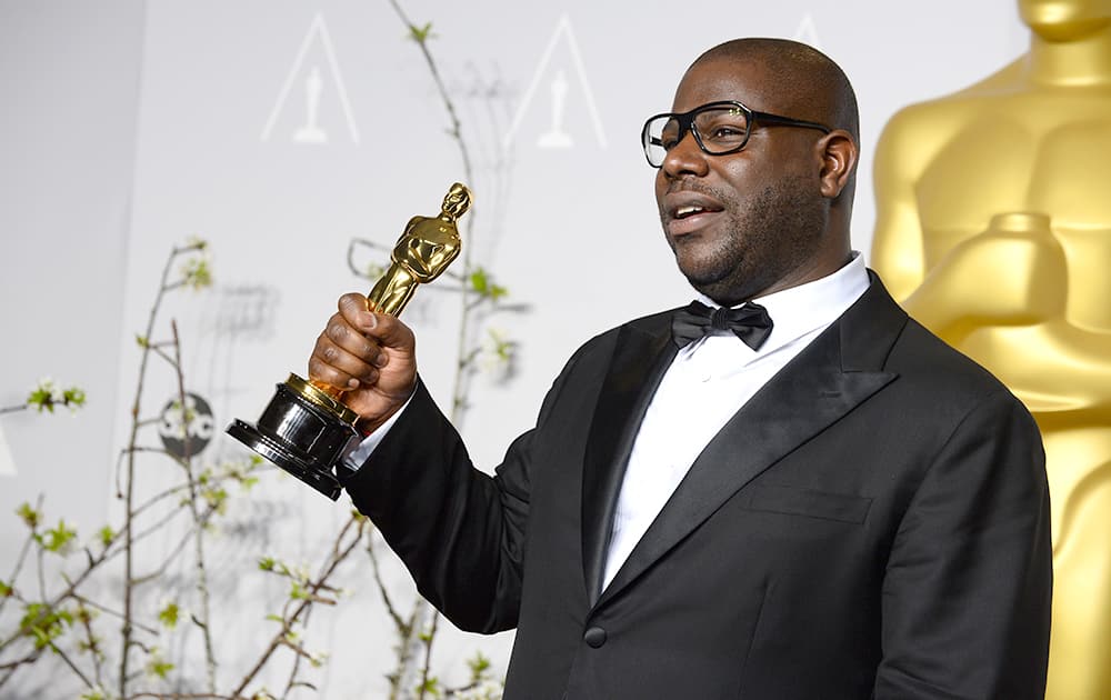 Director Steve McQueen poses in the press room with the award for best picture for '12 Years a Slave' during the Oscars at the Dolby Theatre.