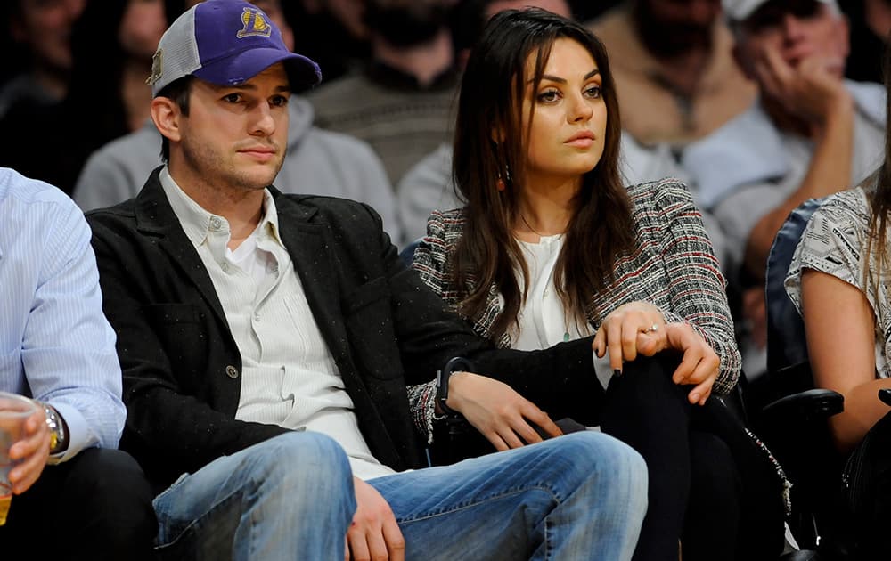 The newly engaged actors Ashton Kutcher and Mila Kunis attend an NBA basketball game between theNew Orleans Pelicans and Los Angeles Lakers in Los Angeles.