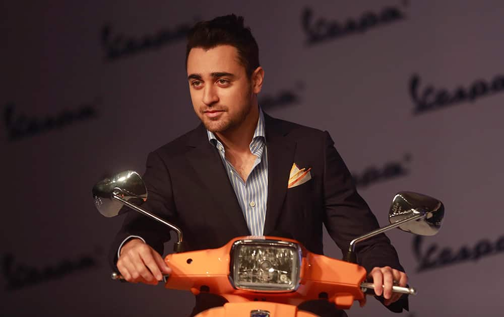 Imran Khan poses for photographs during the launch of 'Vespa S scooters in Mumbai.