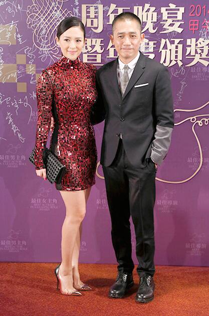 Hong Kong movie star Tony Leung, right, poses with Chinese actress Zhang Ziyi during the annual dinner of the Hong Kong Film Directors' Guild.