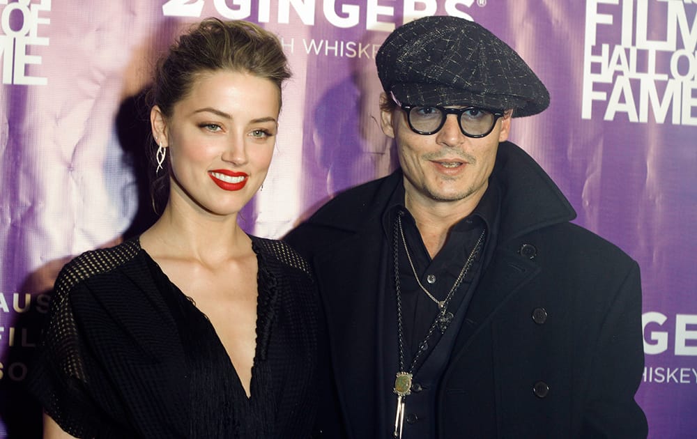 Amber Heard and Johnny Depp arrive at the Texas Film Awards, in Austin, Texas.