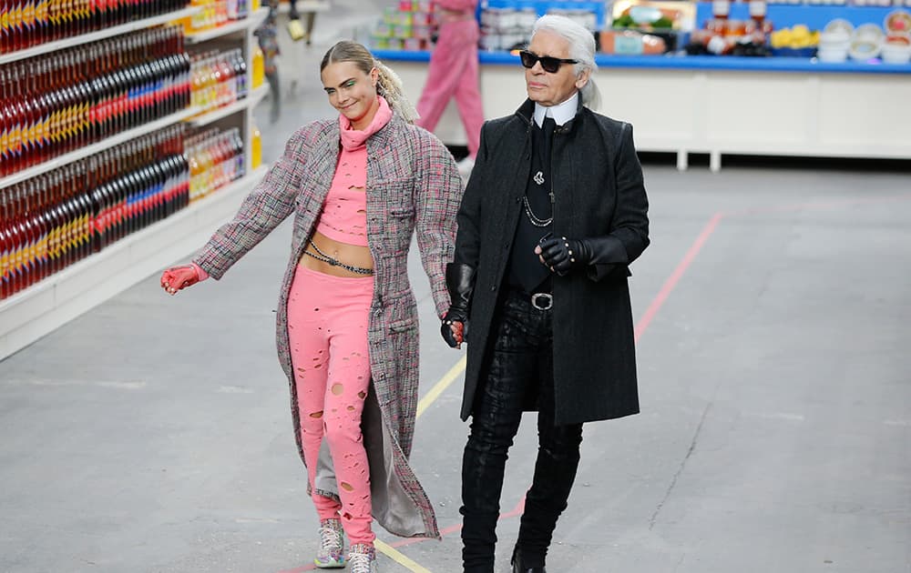 Model Cara Delevingne clowns next to German fashion designer Karl Lagerfeld after the presentation of Chanel's ready to wear fall/winter 2014-2015 fashion collection presented in Paris.