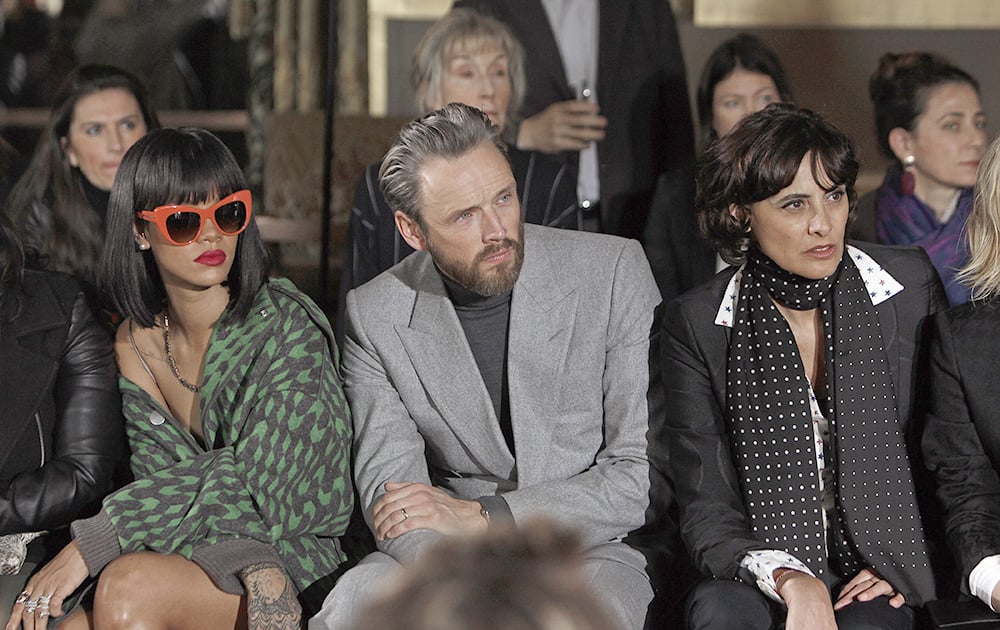 Singer Rihanna, left, Stella McCartney's husband Alasdhair Willis, center, and Ines de la Fressange, attend Stella McCartney's ready-to-wear fall/winter 2014-2015 fashion collection presented in Paris.