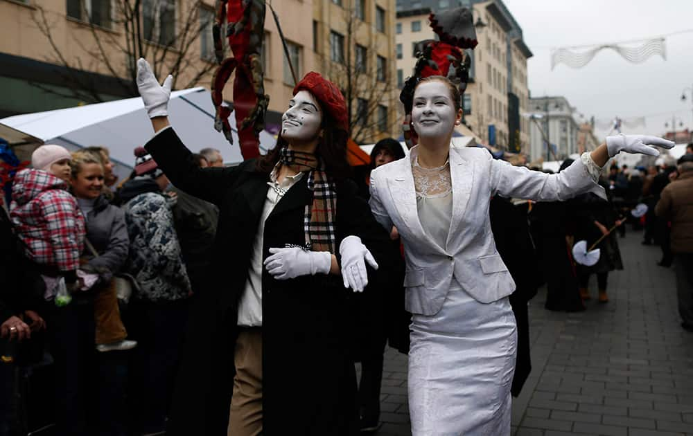 People take part in the theatrical carnival procession during the traditional Kaziukas fair, a large annual folk arts and craft fair in Vilnius, Lithuania.