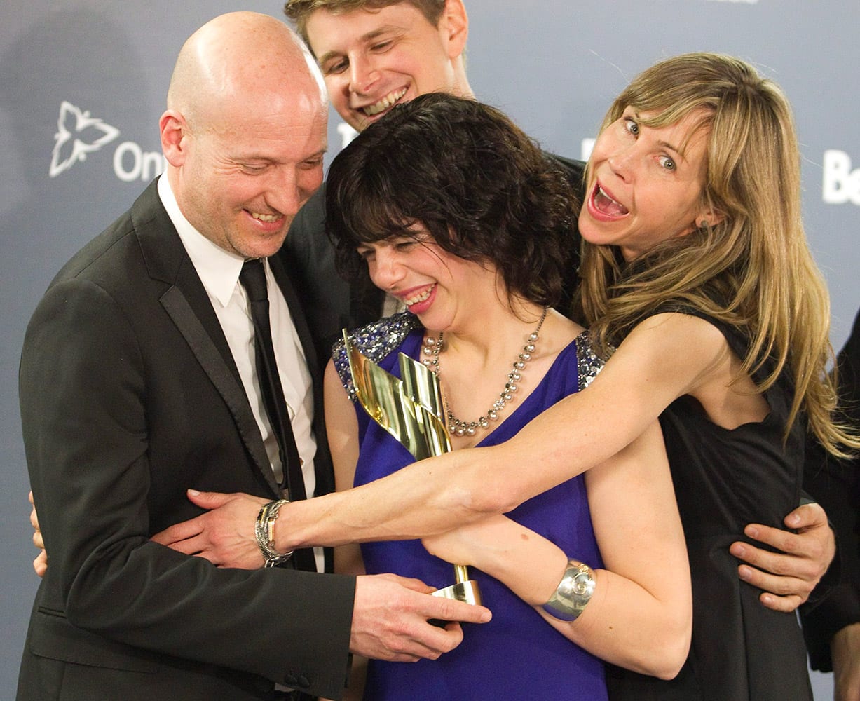 Actor Gabrielle Marion-Rivard, center, with Luc Dery, Louise Archambault and Alexandre Landry with award for best motion picture Gabrielle at the Canadian Screen Awards in Toronto.