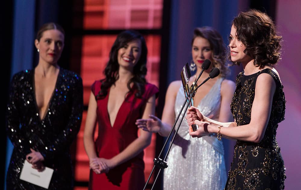 Tatiana Maslany, right, accepts the award for Best Performance by an Actress in a Continuing Leading Dramatic Role for 'Orphan Black' at the Canadian Screen Awards in Toronto.