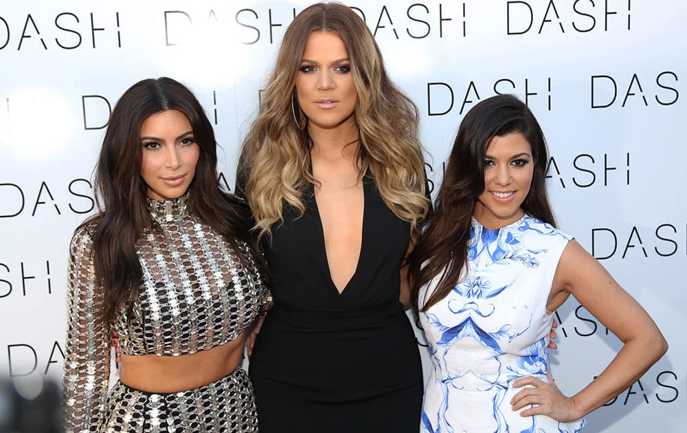 From left, Kim Kardashian, Khloe Kardashian and Kourtney Kardashian attend The Kardashian Family Celebrates the Grand Opening of DASH Miami Beach in Miami Beach, Fla. 