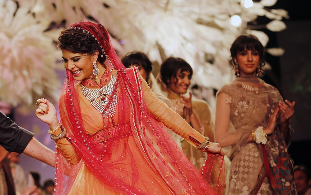 Bollywood actress Jacqueline Fernandez dances on the ramp to showcase a creation by Tarun Tahiliani during the Lakme Fashion Week in Mumbai.