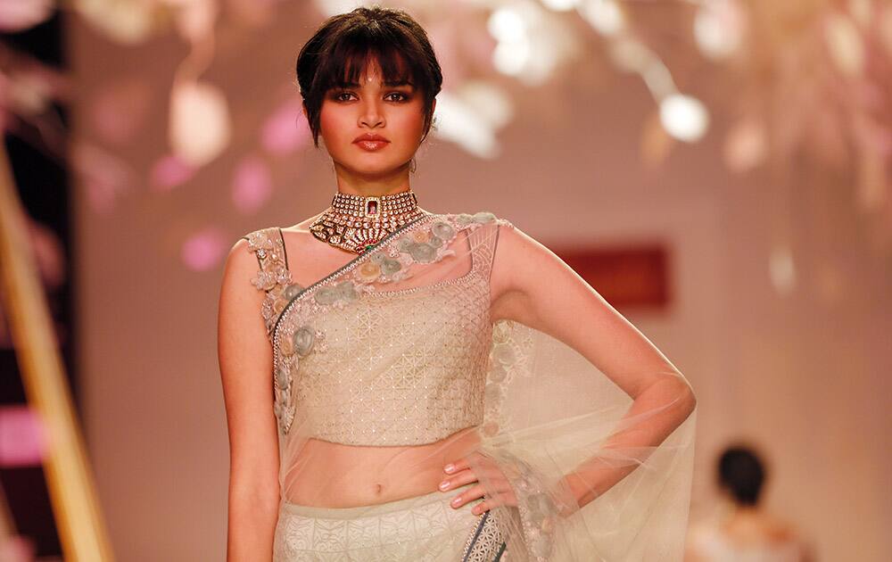 A model walks the ramp to showcase a creation by Tarun Tahiliani during the Lakme Fashion Week in Mumbai.