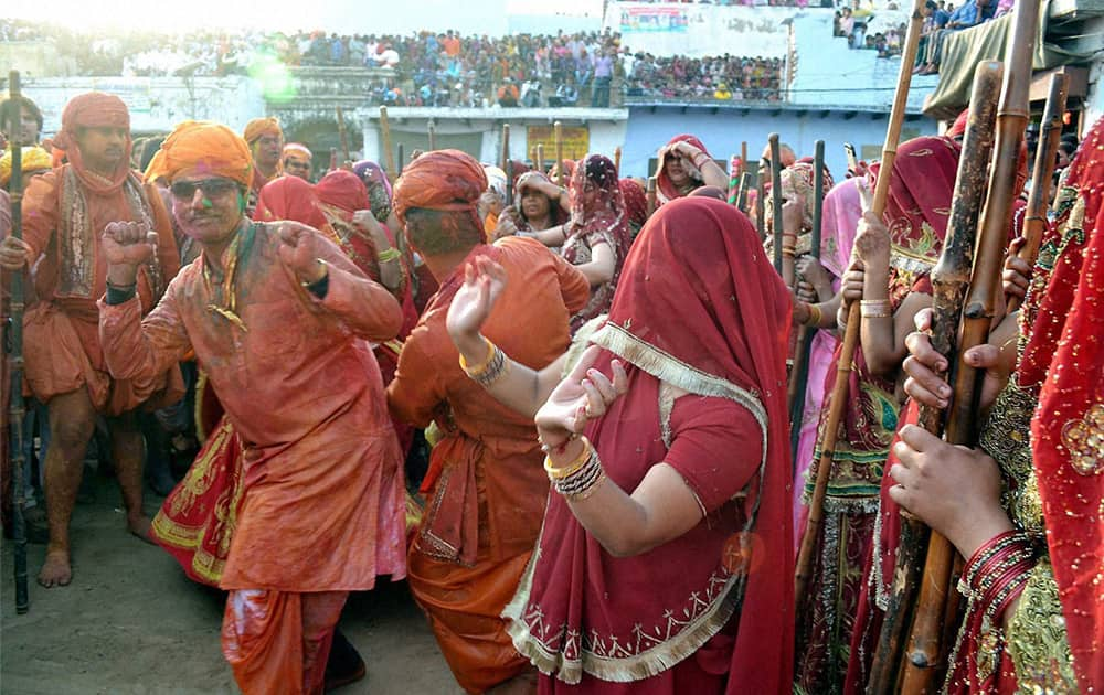 Barsana women beating up men of Nandgaon with sticks during Latthmaar Holi celebration in Mathura.