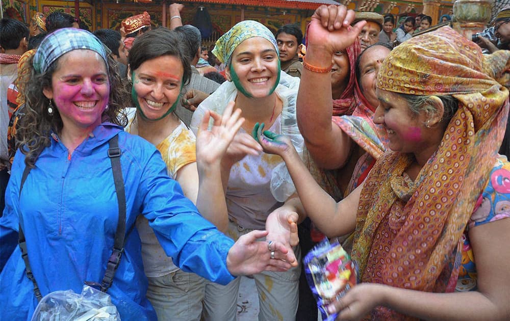 Foreigners take part in Holi celebrations at Dwarkadheesh temple in Mathura.