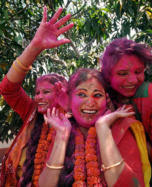  College students playing with colours ahead of Holi festival in Agartala.