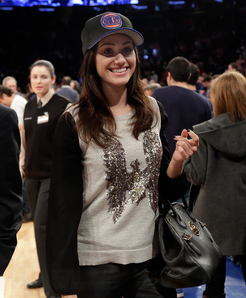 Actress Emmy Rossum, of Showtime's `Shameless` cable television series, wears a Knicks cap as she leaves an NBA basketball game between the Knicks and the Milwaukee Bucks at New York's Madison Square Garden.