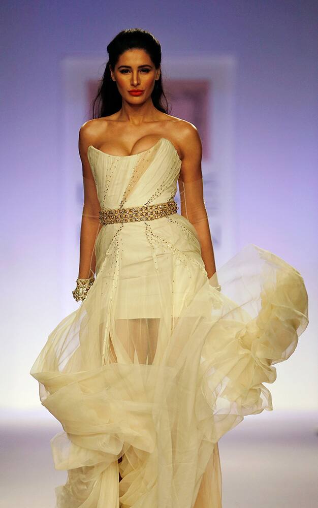 Bollywood actress Nargis Fakhri displays a creation by designer Shehla Khan during the Lakme Fashion Week in Mumbai.