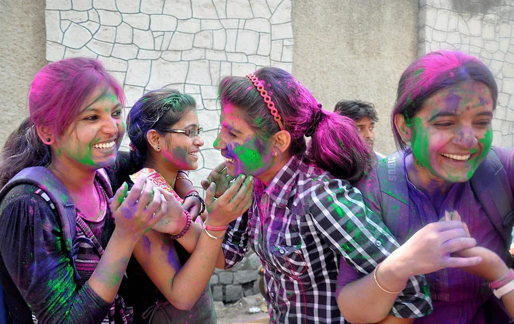 College students playing with colours ahead of Holi festival in Ranchi.