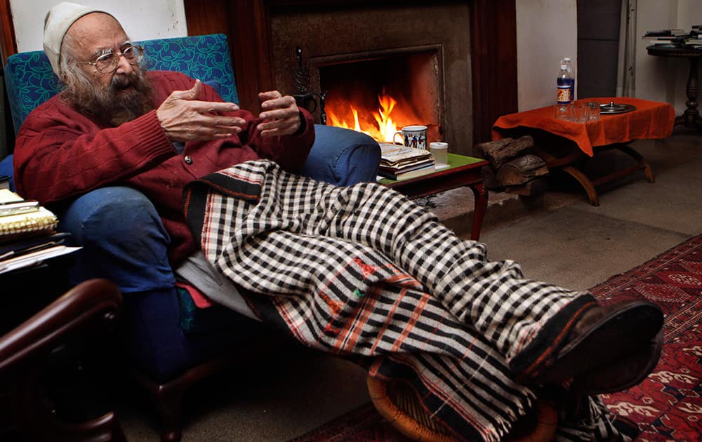 FILE - In this Dec. 20, 2010 file photo, Khushwant Singh, 96, talks sitting next to a fireplace in his house in New Delhi. Singh, a force in India's literary world for more than 60 years, has passed away at his New Delhi home, his daughter said. He was 99.