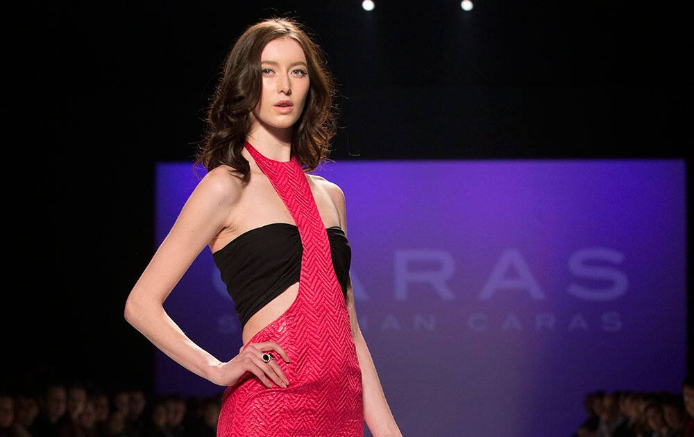 A model wears a creation from Stephan Caras while walking the runway during Toronto Fashion Week.