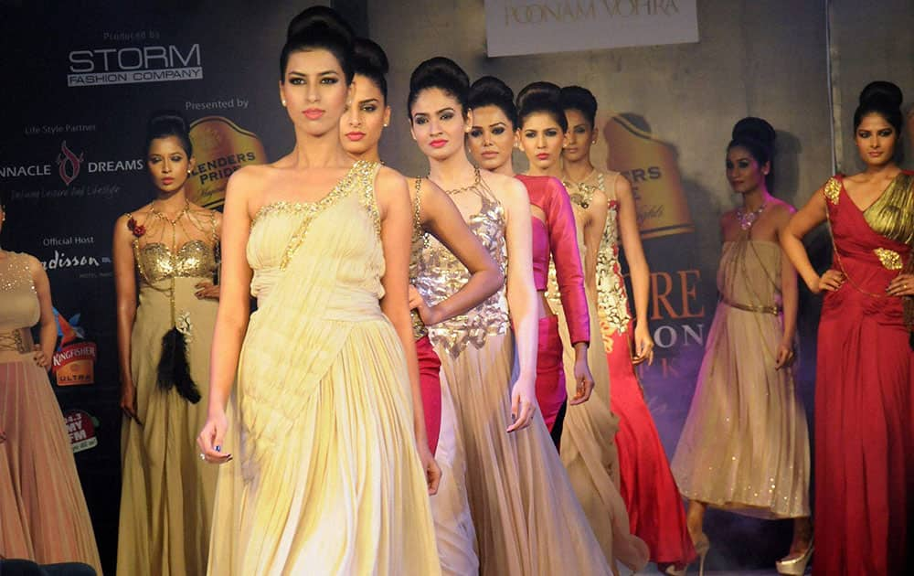 Models walk the ramp during a fashion show in Indore.